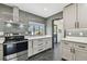 Updated kitchen featuring new appliances, modern cabinets, and stylish gray backsplash at 4560 7Th N Ave, St Petersburg, FL 33713