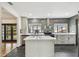Modern kitchen featuring gray tiled backsplash, stainless appliances, and quartz island countertop at 4560 7Th N Ave, St Petersburg, FL 33713
