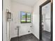 This laundry room features black tile flooring, window, and water heater at 4560 7Th N Ave, St Petersburg, FL 33713