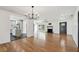 Expansive living area with hardwood floors, modern lighting, and an open layout to the kitchen at 4560 7Th N Ave, St Petersburg, FL 33713