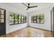 Well-lit living room with hardwood floors and black-framed windows, creating a bright and airy space at 4560 7Th N Ave, St Petersburg, FL 33713