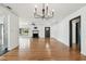 Open-concept living room with hardwood floors, modern fireplace, and seamless flow to the kitchen at 4560 7Th N Ave, St Petersburg, FL 33713
