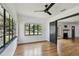 Sunlit living room featuring hardwood floors, expansive windows, and stylish black accents at 4560 7Th N Ave, St Petersburg, FL 33713
