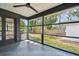 Covered screened-in patio with tiled floor and backyard view through large windows at 4560 7Th N Ave, St Petersburg, FL 33713