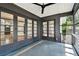 Enclosed patio showcasing tiled flooring and views of the yard through large multi-pane windows at 4560 7Th N Ave, St Petersburg, FL 33713