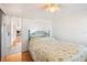 Bright bedroom featuring a large bed, wood floors, and a doorway leading to other parts of the house at 5251 Flint St, Zephyrhills, FL 33542