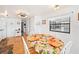 Inviting dining area with a table set for a meal, adjacent to the kitchen at 5251 Flint St, Zephyrhills, FL 33542