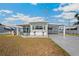 Well-kept home with covered carport and tidy landscaping, creating a welcoming curb appeal in a serene setting at 5251 Flint St, Zephyrhills, FL 33542