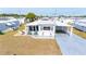 Charming single-story home boasts a covered carport, well-maintained lawn, and cozy outdoor seating area at 5251 Flint St, Zephyrhills, FL 33542