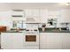 Cozy kitchen with matching white cabinetry, appliances and green countertops at 5251 Flint St, Zephyrhills, FL 33542