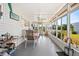 Relaxing sunroom with large windows, ceiling fan, and a cozy dining set at 5251 Flint St, Zephyrhills, FL 33542