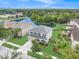 Picturesque aerial shot highlighting a lakeside home with lush landscaping and community amenities like a pool at 5804 Butterfield St, Riverview, FL 33578