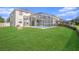 This home has a well-manicured lawn, a screened-in pool, and a patio area at 5804 Butterfield St, Riverview, FL 33578