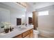This bathroom offers a vanity with a sink, a large mirror, and a shower/tub combo at 5804 Butterfield St, Riverview, FL 33578