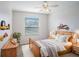 A bedroom, containing a wooden bed frame, a window, and decorative elements at 5804 Butterfield St, Riverview, FL 33578