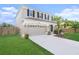Well maintained two-story home with a two car garage and a neatly landscaped front yard at 5804 Butterfield St, Riverview, FL 33578