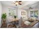Bright living room with hardwood floors, ceiling fans, and large windows that offer plenty of natural light at 5804 Butterfield St, Riverview, FL 33578