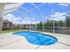 The refreshing screened-in pool offers a place to relax outdoors on a sunny day at 5804 Butterfield St, Riverview, FL 33578
