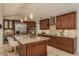 Gourmet kitchen with island, breakfast bar, stainless steel appliances, and custom cabinetry at 5823 Dory Way, Tampa, FL 33615