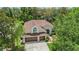 Aerial view showcasing a well-maintained house with a three-car garage at 6038 Palomaglade Dr, Lithia, FL 33547