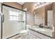 Bathroom featuring an updated vanity with a granite countertop and a glass door shower at 6038 Palomaglade Dr, Lithia, FL 33547