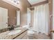 Bathroom featuring granite counters and a shower and tub combo behind a shower curtain at 6038 Palomaglade Dr, Lithia, FL 33547