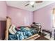 Bedroom with hardwood floors and a wooden bed with unique patterned bedding at 6038 Palomaglade Dr, Lithia, FL 33547
