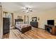 Bedroom featuring hardwood floors, ceiling fan, and a large window for natural light at 6038 Palomaglade Dr, Lithia, FL 33547
