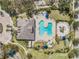 A kidney-shaped pool and playground are a focal point in this community aerial view at 6038 Palomaglade Dr, Lithia, FL 33547