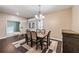 Formal dining room featuring a decorative rug, chandelier, and views into entry at 6038 Palomaglade Dr, Lithia, FL 33547
