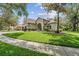 Charming home with a well-maintained lawn and mature landscaping, creating a welcoming and inviting exterior at 6038 Palomaglade Dr, Lithia, FL 33547