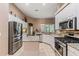 Open kitchen with granite countertops, stainless steel appliances, and center island at 6038 Palomaglade Dr, Lithia, FL 33547