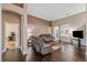 Cozy living room with neutral tones, hardwood flooring, and large windows at 6038 Palomaglade Dr, Lithia, FL 33547