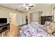 Main bedroom with hardwood floors, ceiling fan and a queen size bed with floral bedding at 6038 Palomaglade Dr, Lithia, FL 33547