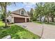 Spacious three-car garage with a paved driveway and well-manicured lawn, offering convenience and curb appeal at 6038 Palomaglade Dr, Lithia, FL 33547