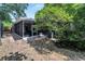 Enclosed back porch with stone pavers creates a relaxing backyard retreat at 6110 N Suwanee Ave, Tampa, FL 33604