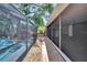 View of the screened-in pool from backyard walkway at 6110 N Suwanee Ave, Tampa, FL 33604