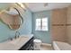 Elegant bathroom features vanity with sink, mirror, toilet, tub, and tiled walls at 6110 N Suwanee Ave, Tampa, FL 33604