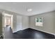 Bedroom featuring modern ceiling light, window, and black wooden floors at 6110 N Suwanee Ave, Tampa, FL 33604
