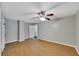 Bedroom featuring closet, a ceiling fan, and neutral-colored walls and wood flooring at 6110 N Suwanee Ave, Tampa, FL 33604