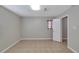 Cozy bedroom with a window, tile floor, and neutral paint at 6110 N Suwanee Ave, Tampa, FL 33604