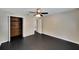 Bedroom featuring open closet, a ceiling fan, and neutral-colored walls and flooring at 6110 N Suwanee Ave, Tampa, FL 33604
