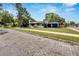 View of the charming blue and white home from the brick paved street at 6110 N Suwanee Ave, Tampa, FL 33604