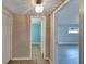 Hallway with neutral paint and stylish lighting fixture leading to rooms at 6110 N Suwanee Ave, Tampa, FL 33604
