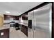 Kitchen with stainless steel appliances, granite countertops and dark wood cabinets at 6110 N Suwanee Ave, Tampa, FL 33604