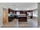 Spacious kitchen featuring an island, granite countertops, stainless steel appliances, and tiled flooring at 6110 N Suwanee Ave, Tampa, FL 33604