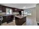Updated kitchen with a large island, granite countertops, stainless steel appliances and dark wood cabinets at 6110 N Suwanee Ave, Tampa, FL 33604