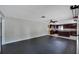 Open concept living room with dark hardwood floors leads into a modern kitchen with a central island at 6110 N Suwanee Ave, Tampa, FL 33604