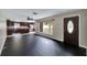 Spacious living room featuring hardwood floors that connect to the modern kitchen at 6110 N Suwanee Ave, Tampa, FL 33604