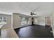 Open concept living space with hardwood floors, flowing into a modern kitchen and dining area at 6110 N Suwanee Ave, Tampa, FL 33604